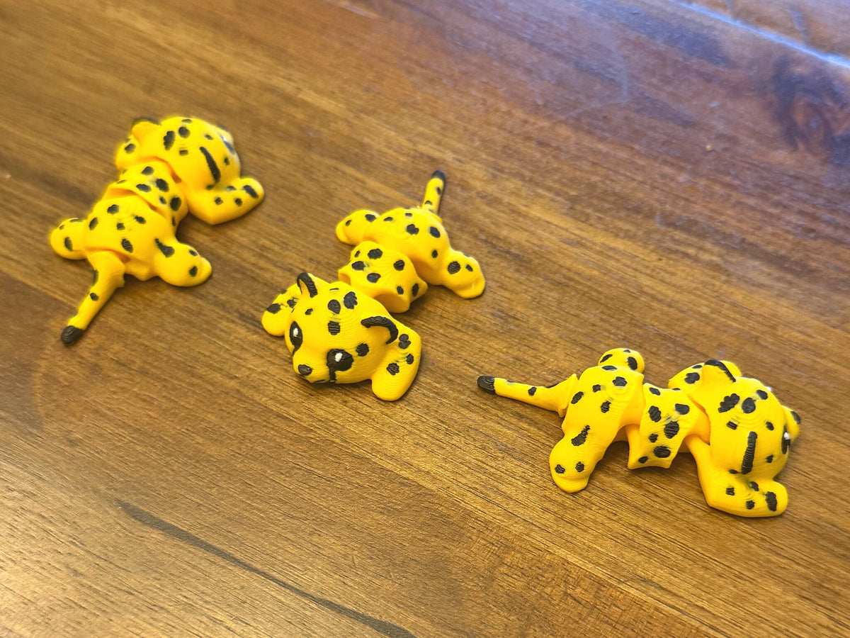 Three flexi cheetahs on a table shown from multiple angles