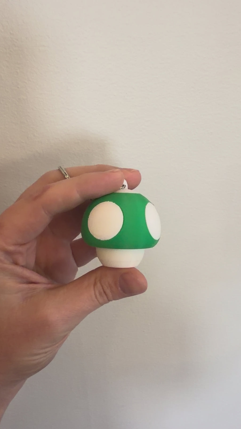 Video of the green Mushroom Clicker Keychain being clicked between finger and thumb
