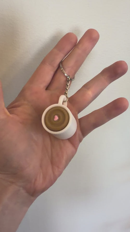 Video of the Coffee Cup Clicker Keychain resting in an open hand with its keyring